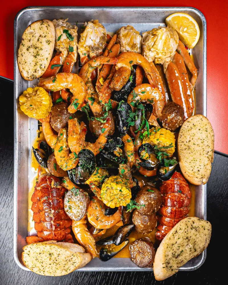 Seafood boil platter with lobster, King prawns, snow crab, mussels and Cajun sauce at Seafood City Birmingham